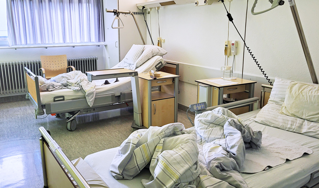 Zwei leere Krankenhausbetten in einem Mehrbettzimmer
